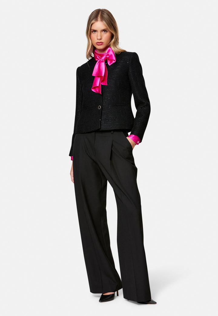 Woman wearing black suit over Silk Pussybow Blouse