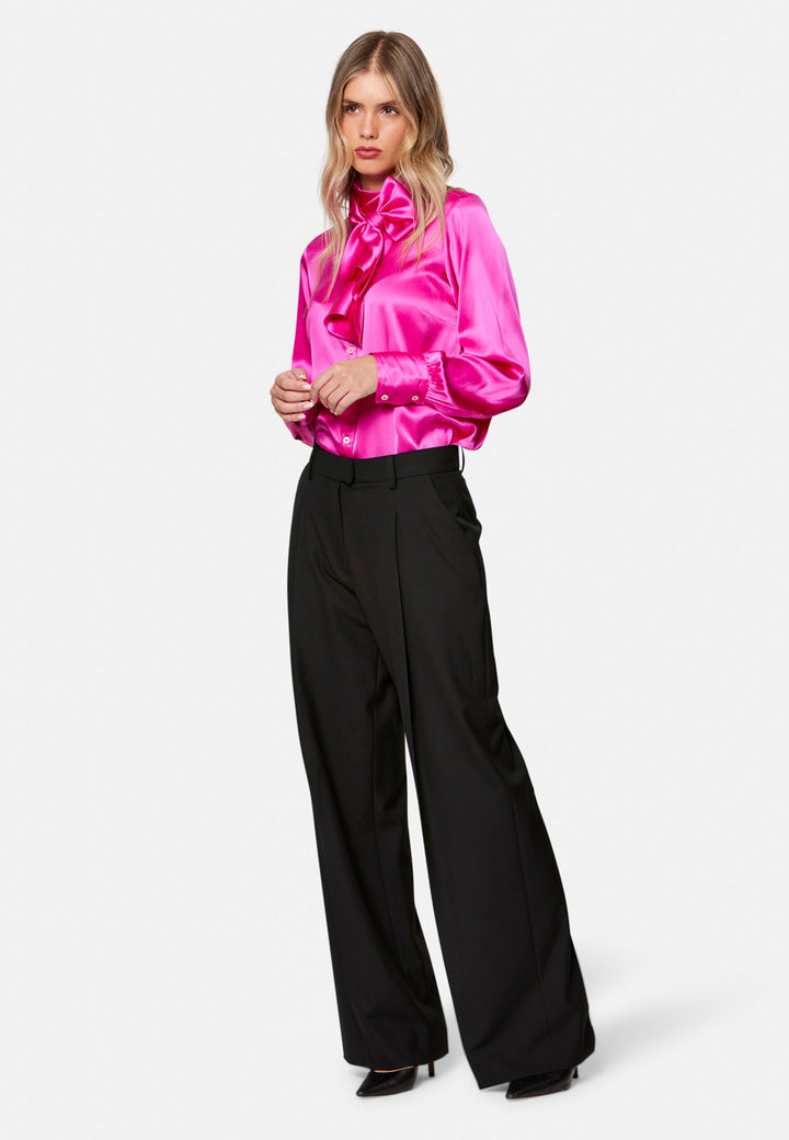 Woman wearing pink Silk Pussybow Blouse and black trouser