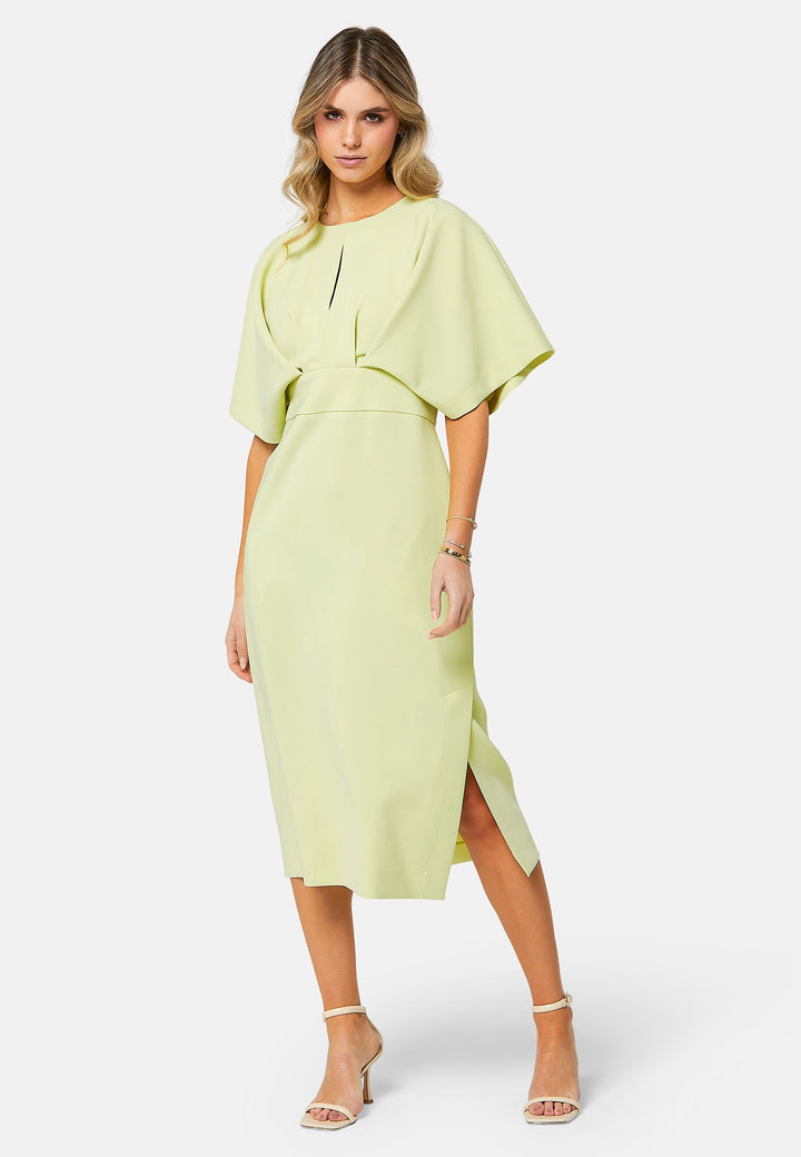 A radiant piece designed to elevate your warm-weather wardrobe. Drenched in a vibrant lime hue, this dress effortlessly captures the essence of summer elegance. The relaxed silhouette drapes gracefully to a flattering mid-calf length, ensuring both comfort and style on sun-filled days. Highlighted by pronounced pleats at the center front bodice and a subtle front slit, it infuses a touch of allure into its design.