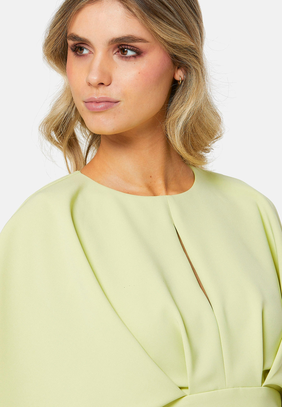 A radiant piece designed to elevate your warm-weather wardrobe. Drenched in a vibrant lime hue, this dress effortlessly captures the essence of summer elegance. The relaxed silhouette drapes gracefully to a flattering mid-calf length, ensuring both comfort and style on sun-filled days. Highlighted by pronounced pleats at the center front bodice and a subtle front slit, it infuses a touch of allure into its design.