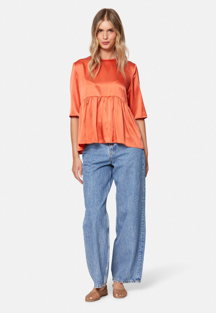 Woman wearing silk orange blouse