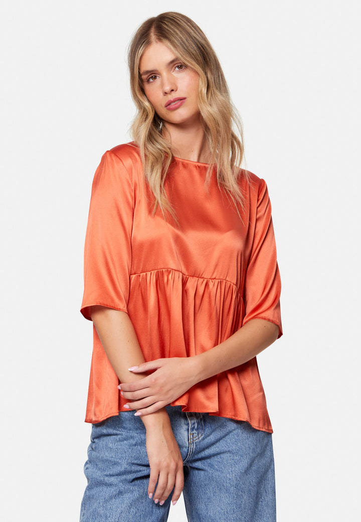 Woman wearing silk orange blouse