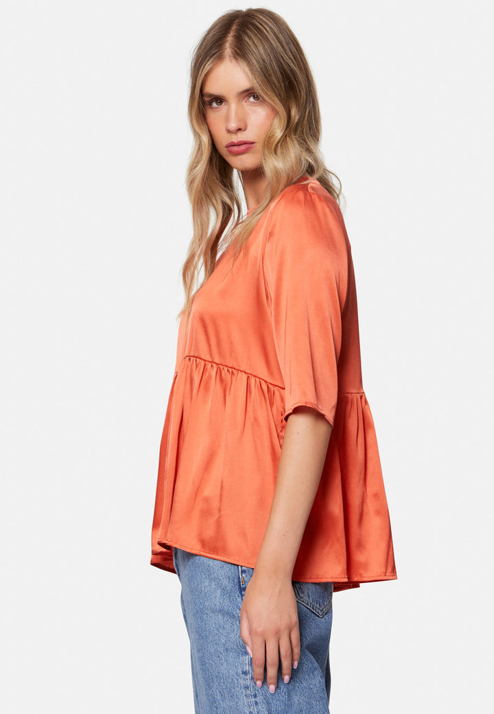 Woman wearing silk orange blouse