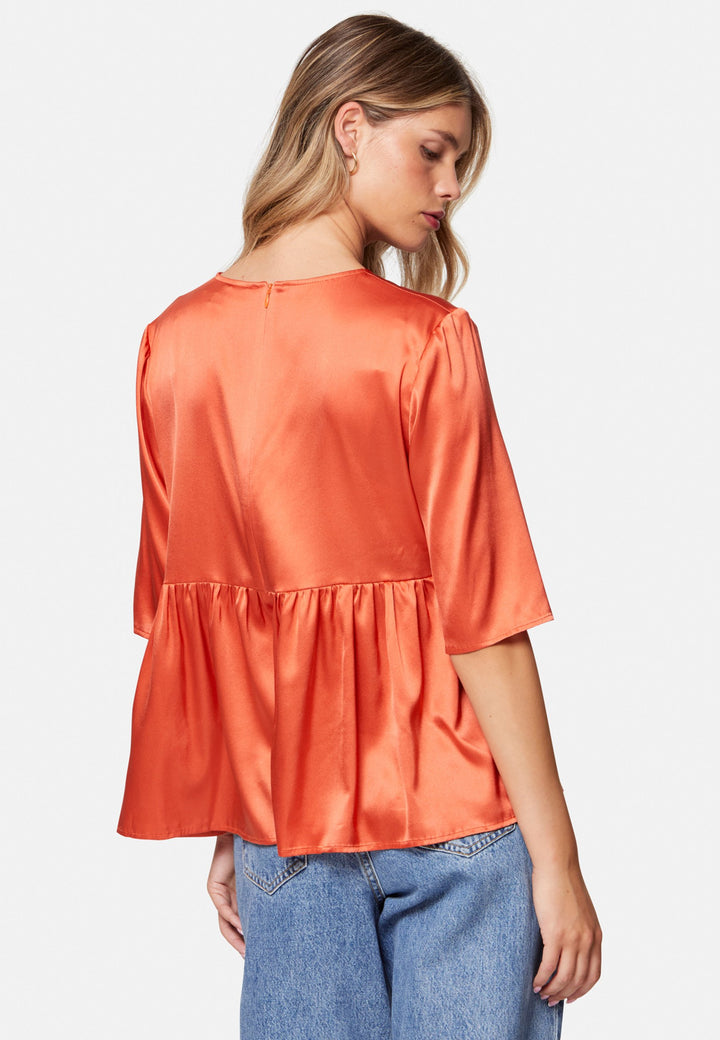Woman wearing silk orange blouse