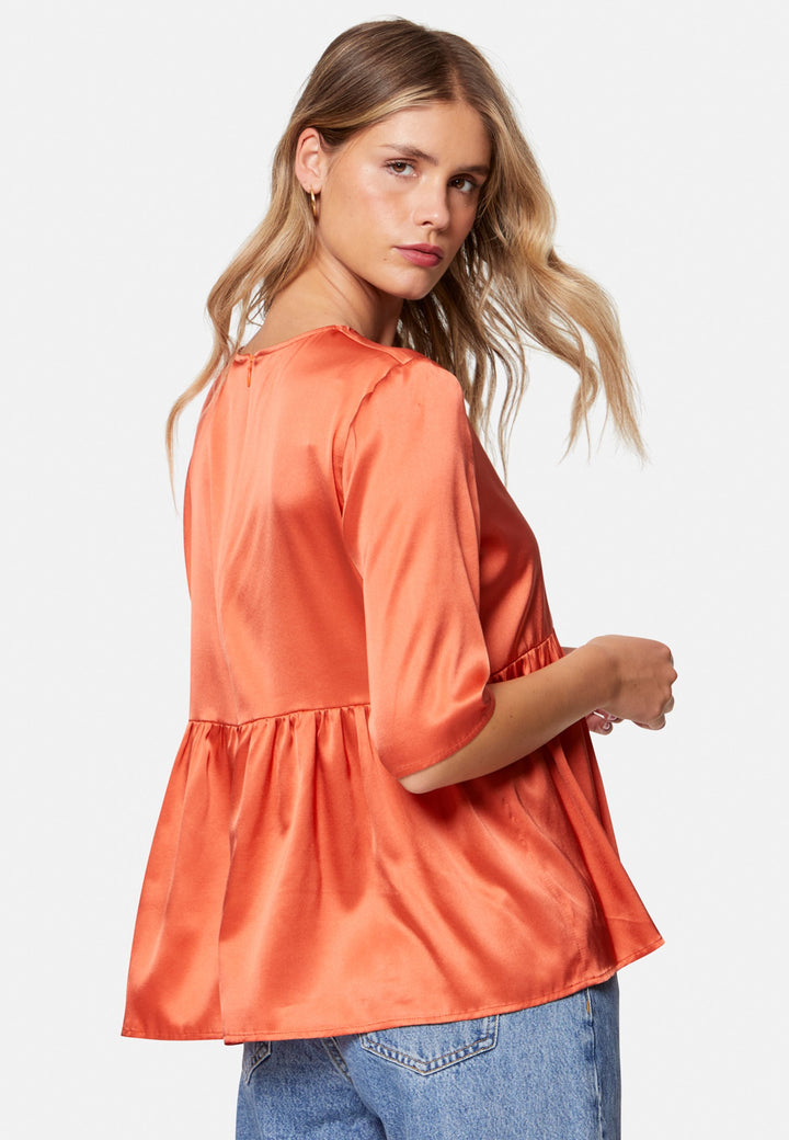Woman wearing silk orange blouse