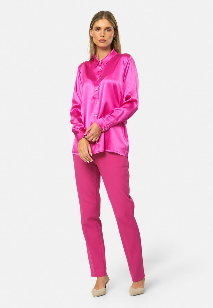 Women wearing a pink fuchsia silk satin shirt