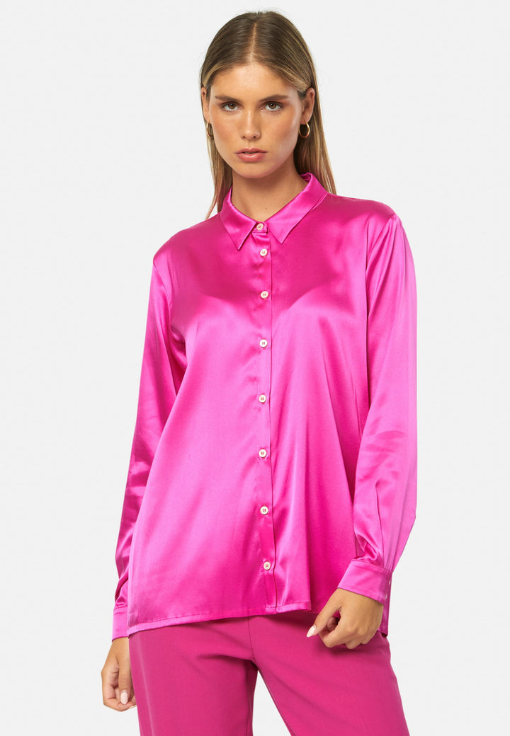 Women wearing a pink fuchsia silk satin shirt
