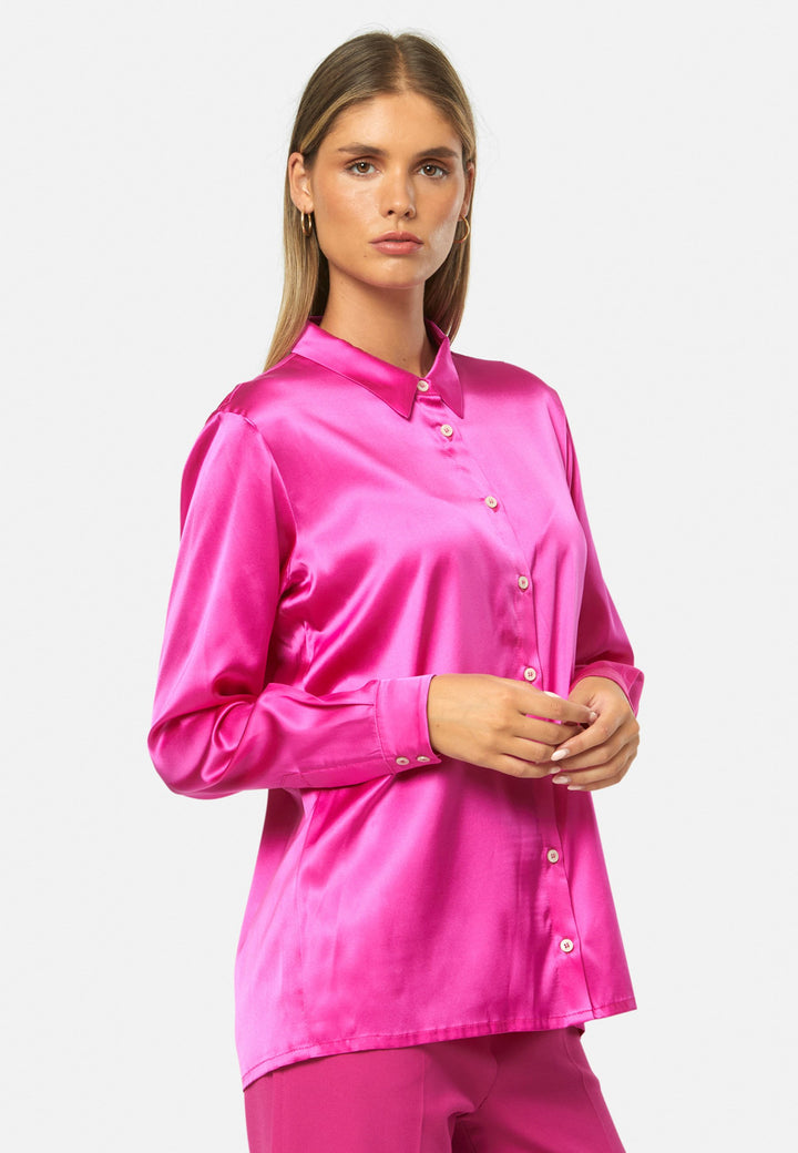 Women wearing a pink fuchsia silk satin shirt
