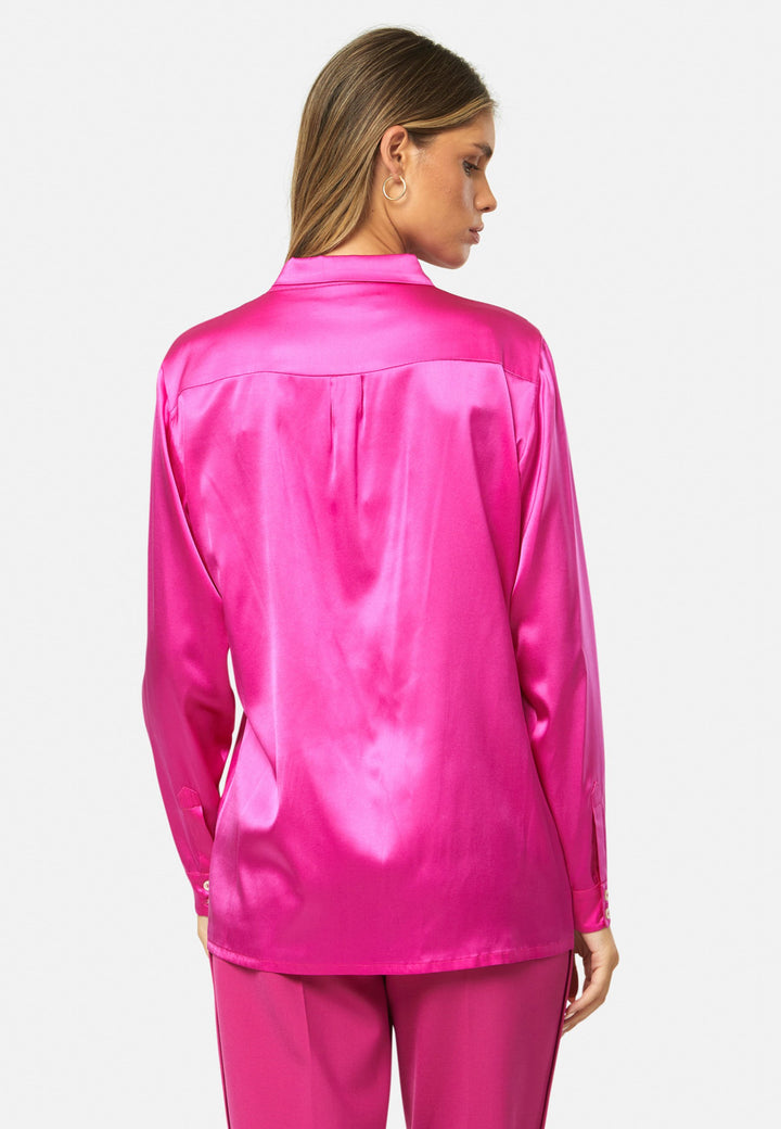 Women wearing a pink fuchsia silk satin shirt