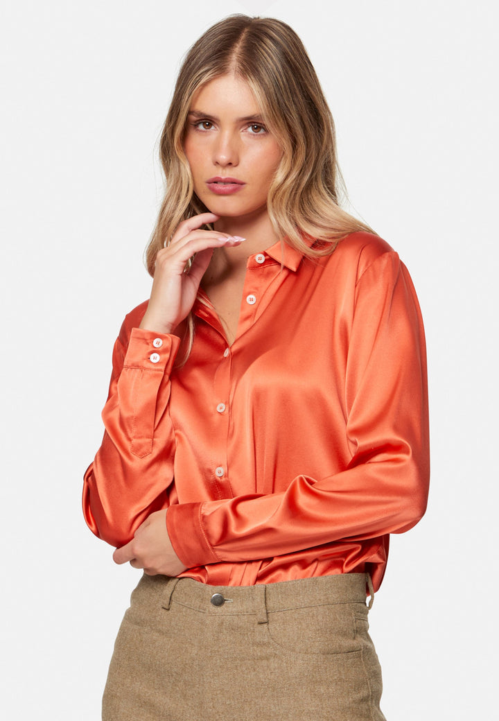 Woman wearing orange silk satin shirt
