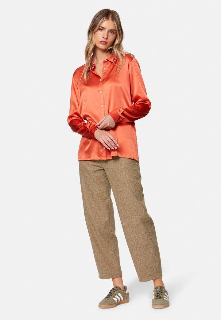 Woman wearing orange silk satin shirt