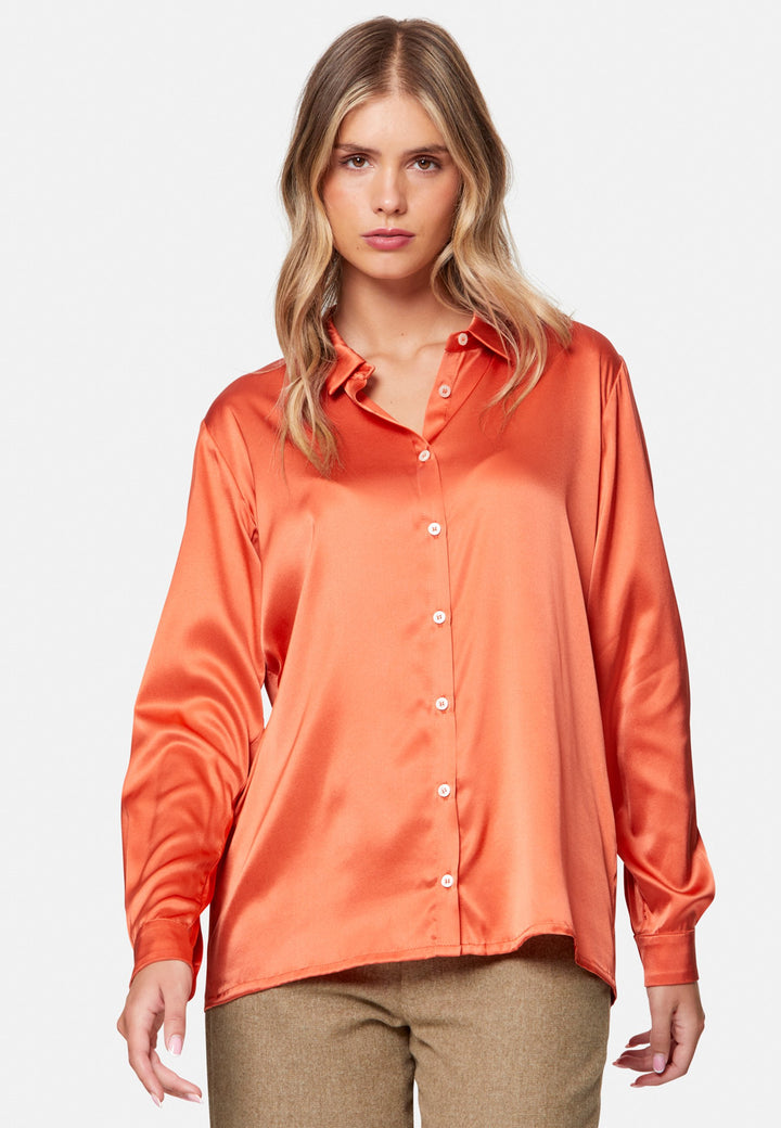 Woman wearing orange silk satin shirt