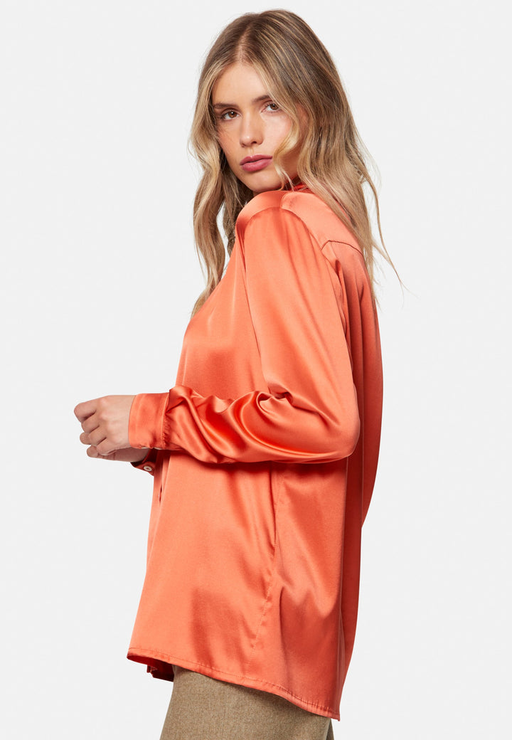 Woman wearing orange silk satin shirt