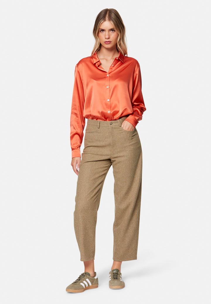 Woman wearing orange silk satin shirt