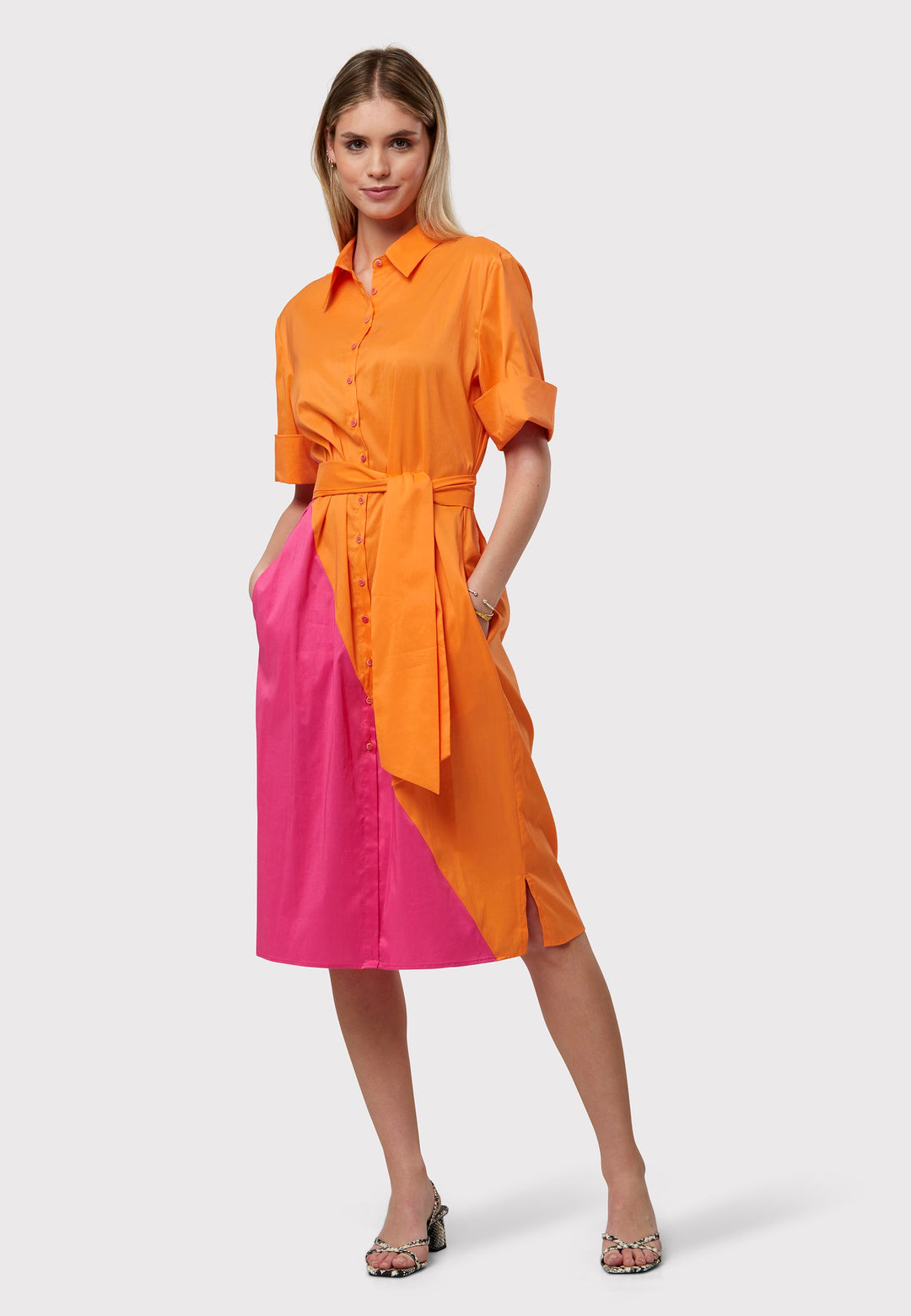Introducing Bella, A bicoloured Shirt dress with a bold asymmetric panel, on both the front and back in vivid shades of orange and pink. Your go-to shirt dress. Crafted with a sleek edge, this dress boasts a detachable belt that cinches the waist. The relaxed silhouette drapes over the hips with practical side seam pockets.