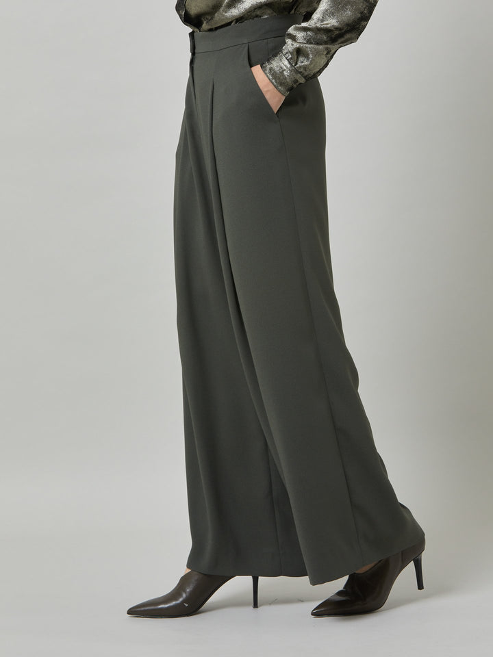 Charlize, a wide-leg palazzo pant. crafted in a satin back crepe in rich olive features deep pleats, sharp front crease & side pockets. A high-waisted trouser made to take you from desk to dinner with a relaxed & refined silhouette. Style with flats or dress up with heels.