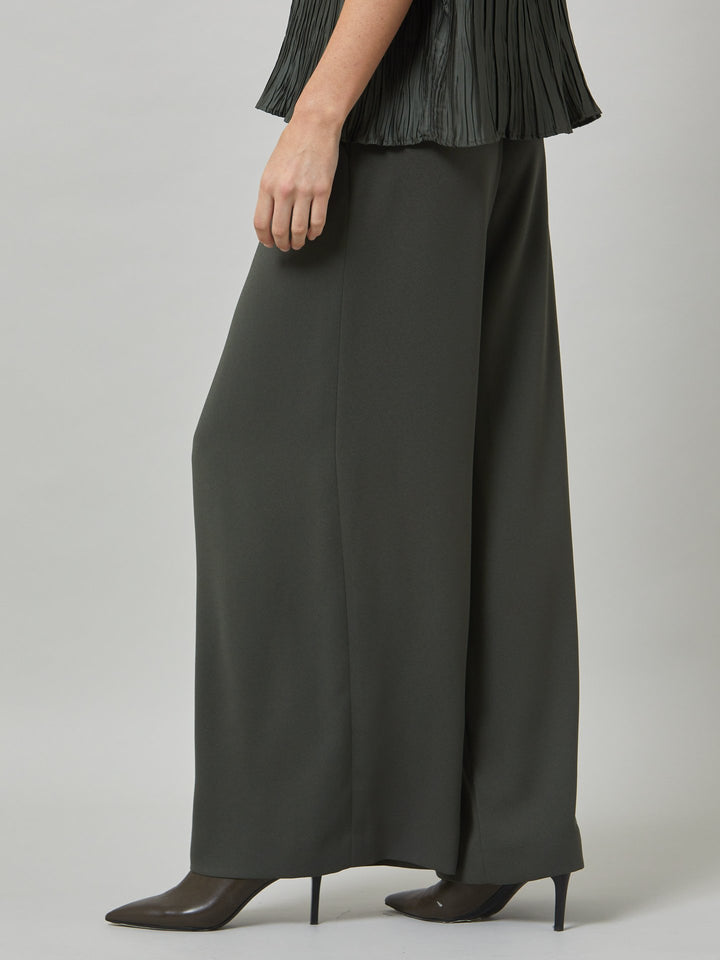 Charlize, a wide-leg palazzo pant. crafted in a satin back crepe in rich olive features deep pleats, sharp front crease & side pockets. A high-waisted trouser made to take you from desk to dinner with a relaxed & refined silhouette. Style with flats or dress up with heels.