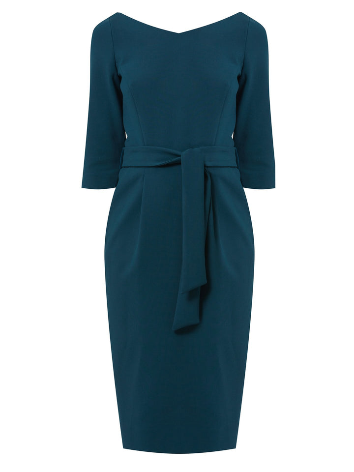 Introducing Clara, an exquisite variation of our beloved silhouette. This captivating dress in a luscious jade hue features a graceful wide V-neckline. Crafted with a hint of elastane and features elegant front pleats at the waist, offering a comfortable and figure-enhancing fit. Complete with convenient pockets and a flattering knee length. Clara is the ideal choice for various occasions.