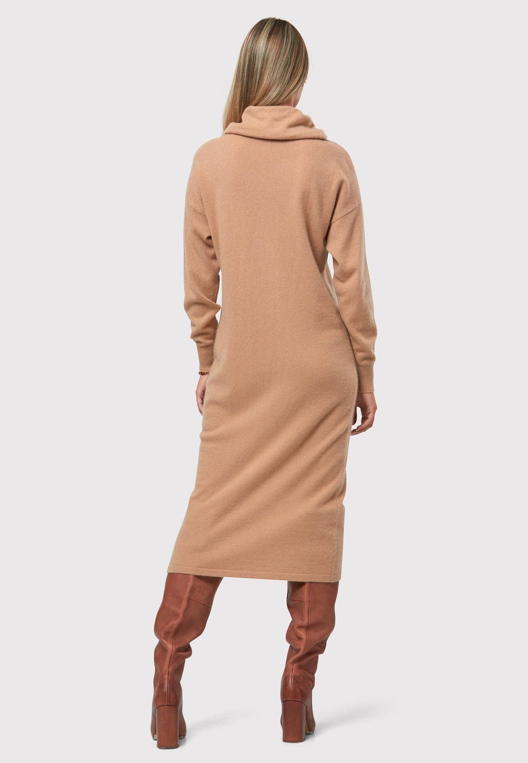 Have you met the Elora Cashmere Dress? A chic and versatile addition to your wardrobe. This midi-length dress features a loose and drapey polo neck, exuding effortless elegance. With full-length sleeves and a tight ribbed cuff, it offers a stylish and comfortable fit. Crafted from luxurious cashmere, this dress combines sophistication and comfort.