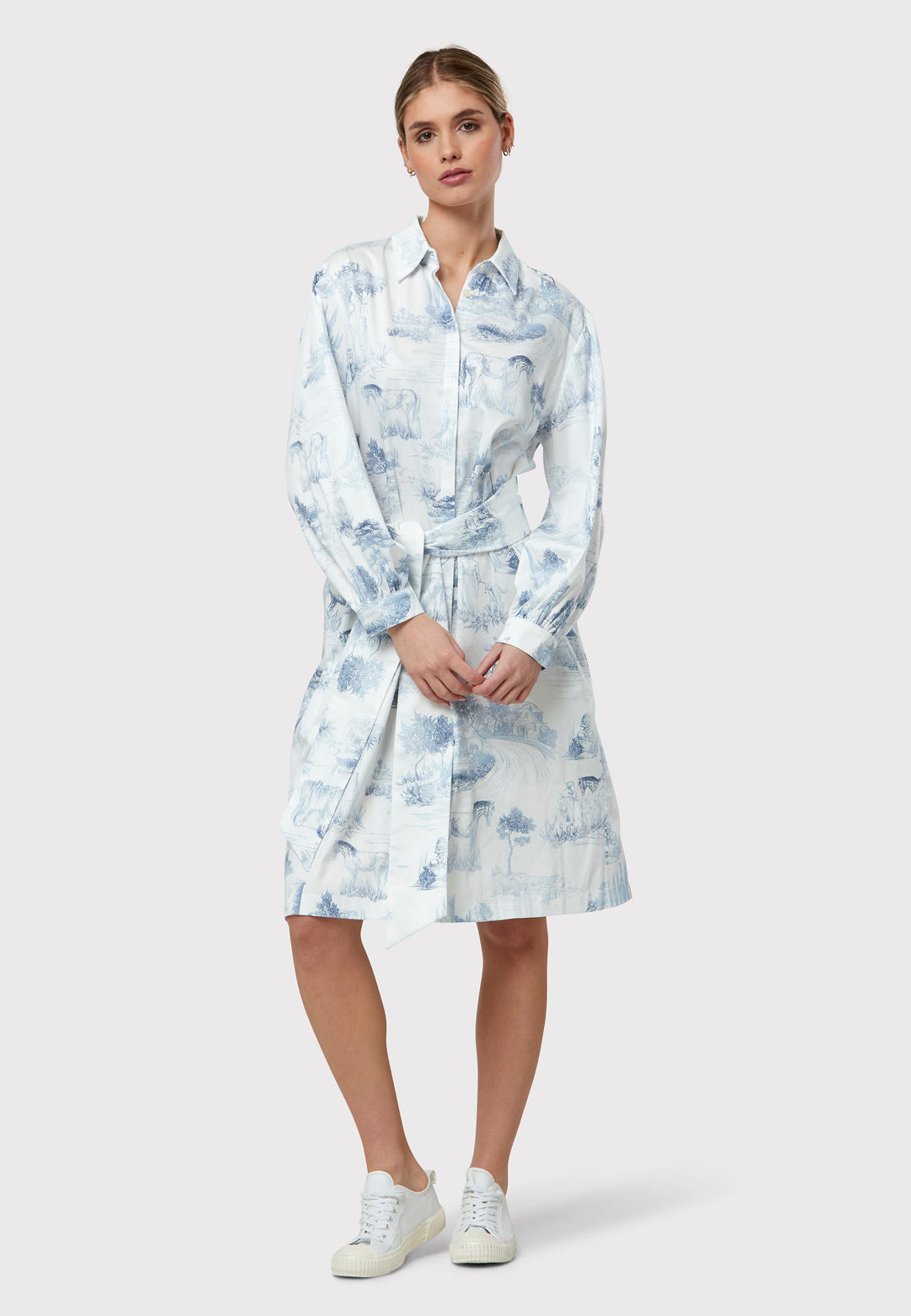 Opt for Odette. Crafted from crisp cotton in a blue and white toile de Jouy print, this easy-fit shirtdress favouriteversatile style. Accentuate your waist with the matching belt for a tailored look that flatters the silhouette. Whether styled as a dress or worn open over your favourite summer trousers, Odette effortlessly combines elegance with comfort for a chic ensemble.