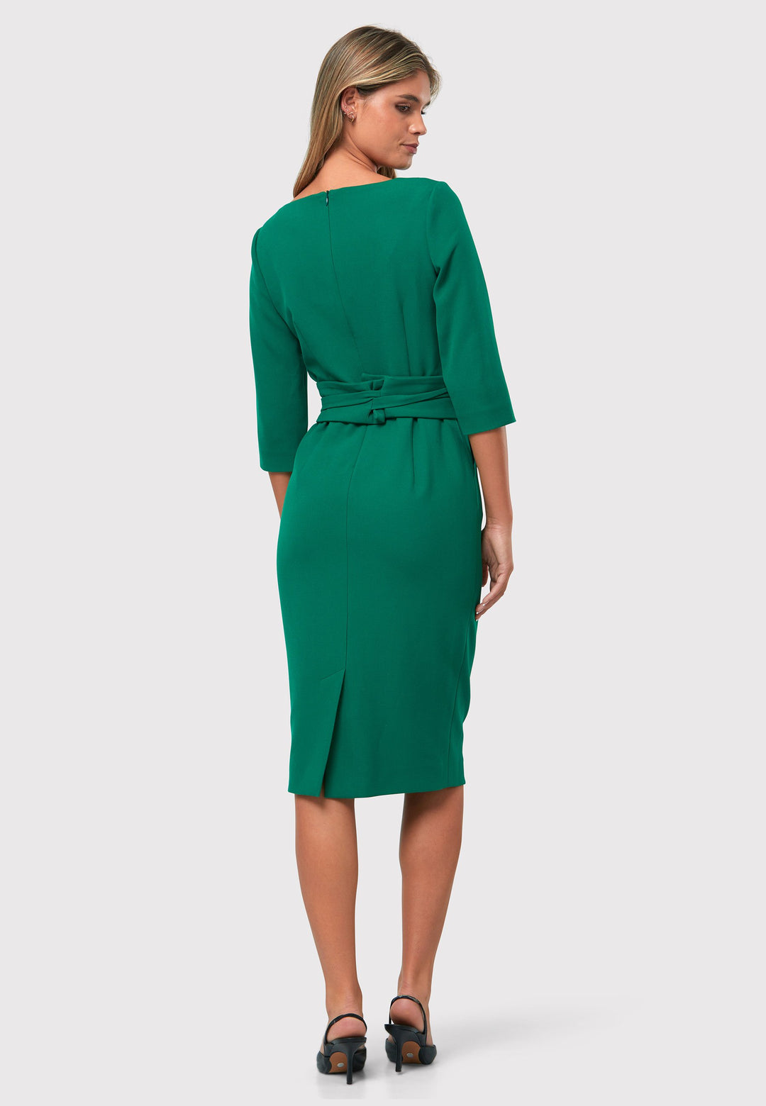 Introducing the Ophelia Dark Emerald Green Dress, a timeless and impeccably tailored silhouette. This expertly crafted dress features a form-flattering design with convenient pockets, a detachable belt, and a pencil skirt that falls to a chic mid-calf length. The sophisticated V-neckline adds an elegant touch to the overall look. Crafted from sustainably sourced fibers with a hint of stretch, this dress ensures both comfort and ease of movement. 
