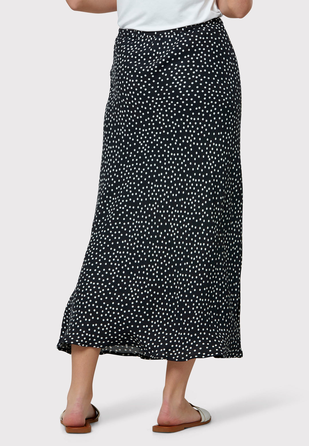 Experience the charm of the Peyton Navy and White Polka Dot Skirt, beautifully crafted with a graceful bias cut for an elegant drape. This mid-calf length design features a flattering high-waisted silhouette in classic navy and white polka dot viscose crepe fabric, echoing 30's glamour.