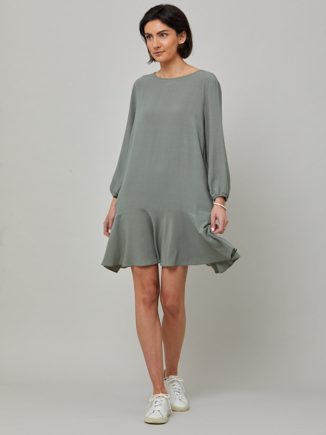 Sheila, a great everyday dress. Crafted in our fluid lichen green viscose crepe. A flirty knee-grazing shift dress with a soft elasticated cuff sleeve that falls to a deep frill hem with a jewel neckline and key-hole back detail. For everyday comfort style with trainers. Elevate your mood with this fun piece.