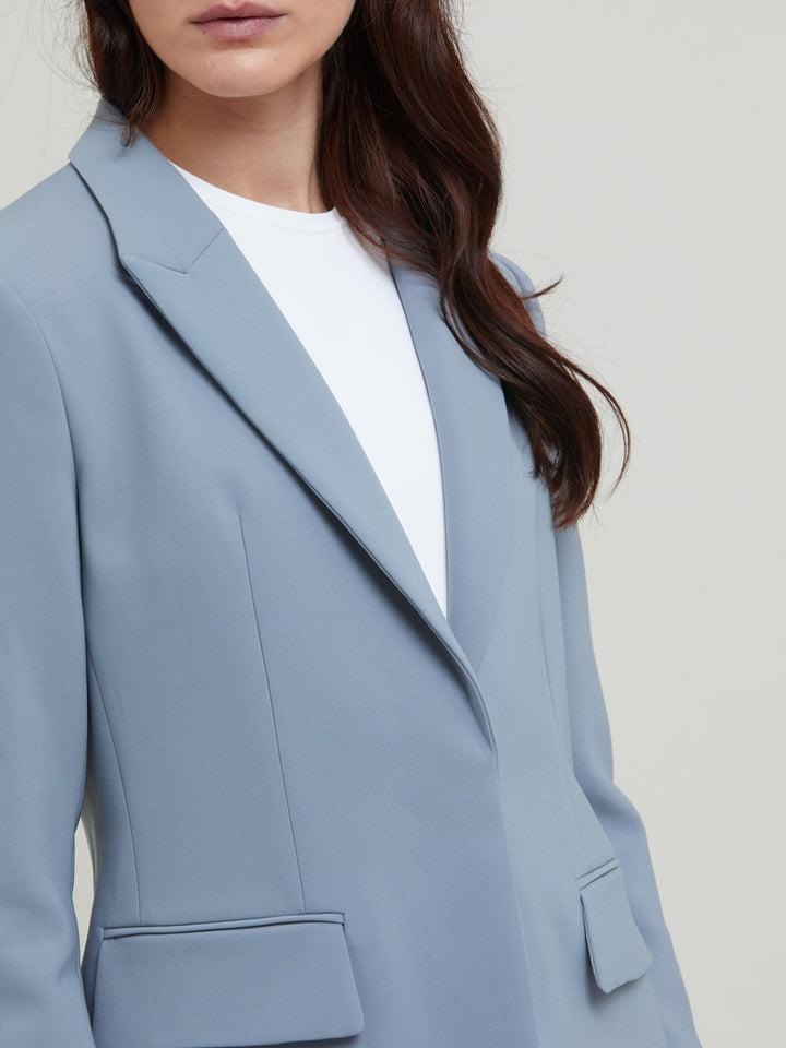 Tina, the most elegant of jackets. A classic semi-fitted silhouette in a sophisticated smoky blue with lapel collar, flap pockets, lined and tailored with a one-button fastening. Designed in Ireland by Helen McAlinden. Made in Europe. Free shipping to the EU & UK.