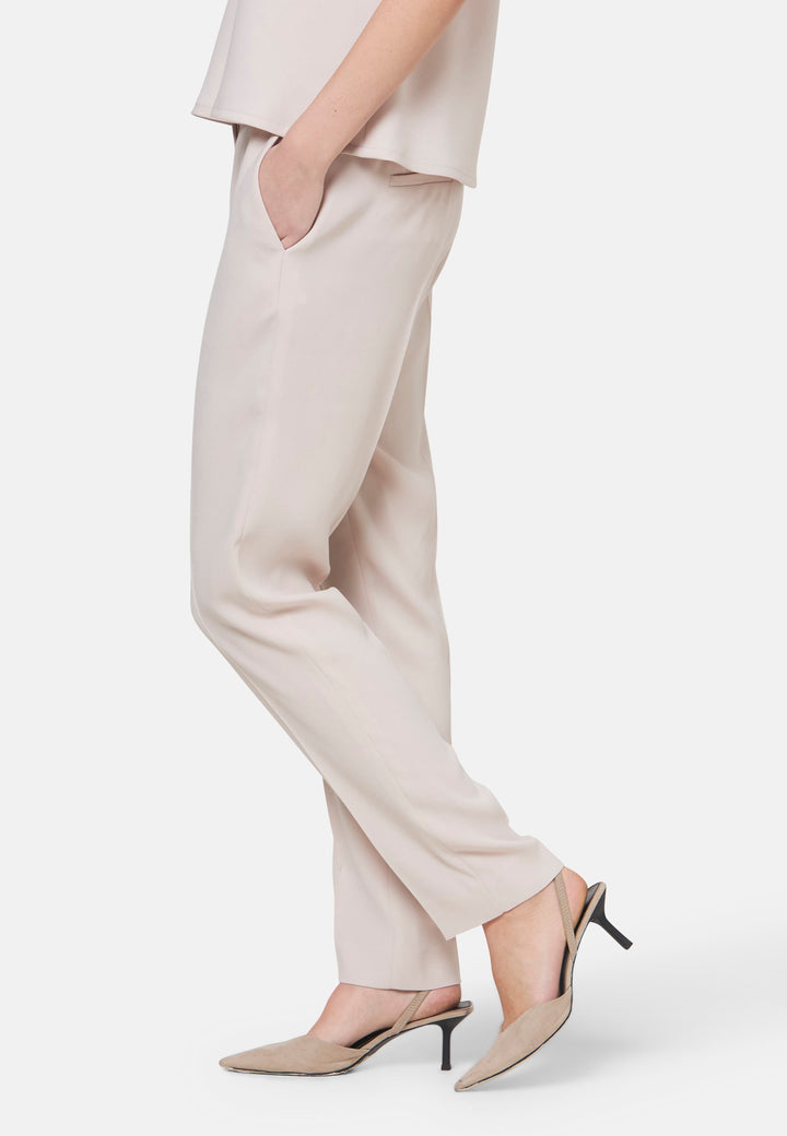 Woman wearing natural pearl pants
