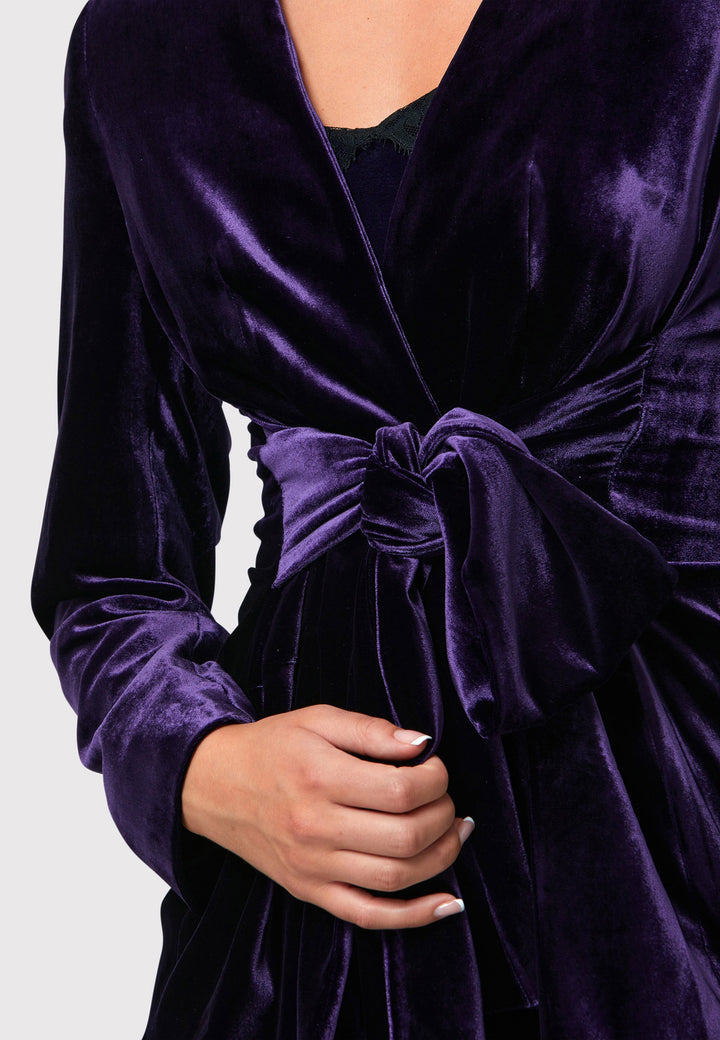 The Aurora Twilight Plum Velvet Jacket is an elegant addition to your evening wardrobe. Designed with a wrap front and a self-tie attached belt, allowing for a customizable fit. Pair with the matching Naomi trousers for a full glam look, or style it with the coordinating Jill trousers for a chic and simple style.