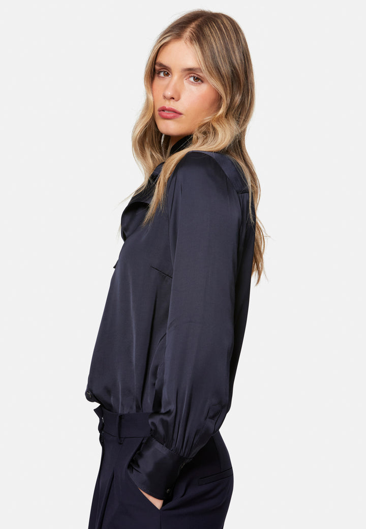 Woman wearing a dark blue outfit on a white background