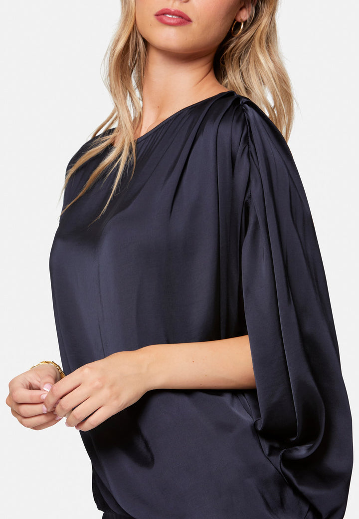 woman wearing navy satin assymetric blouse