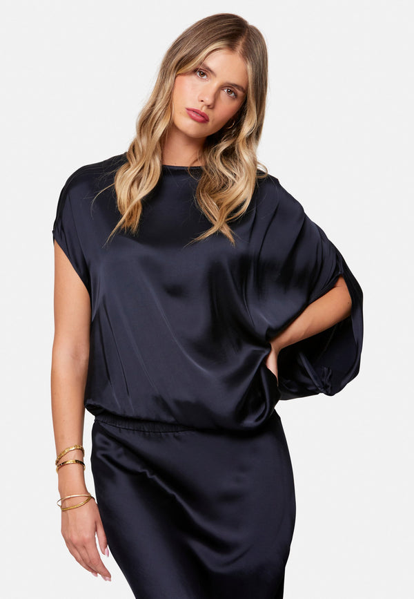woman wearing navy satin assymetric blouse