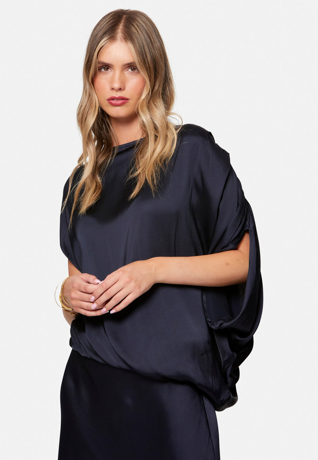 woman wearing navy satin assymetric blouse