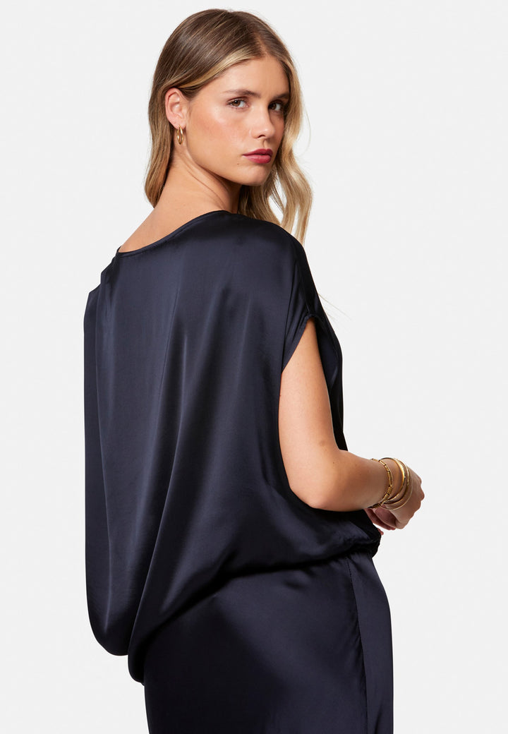 woman wearing navy satin assymetric blouse