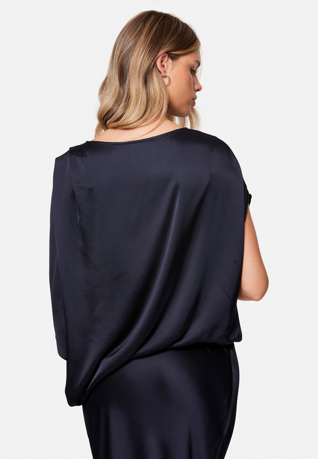 woman wearing navy satin assymetric blouse