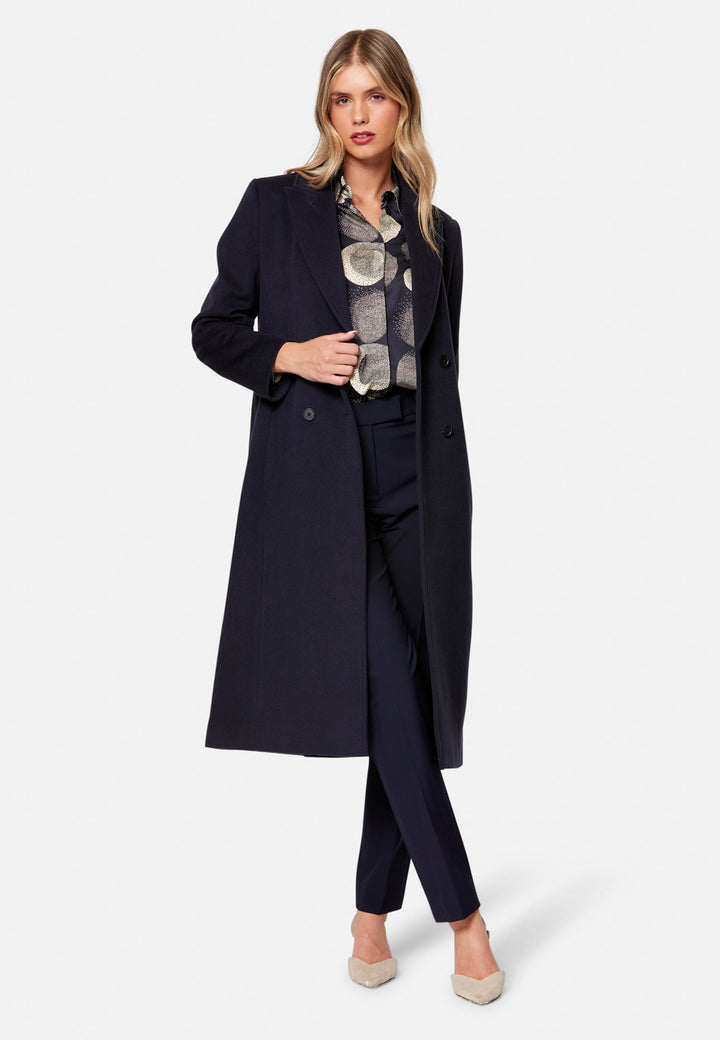 woman wearing double breast cashmere coat in navy