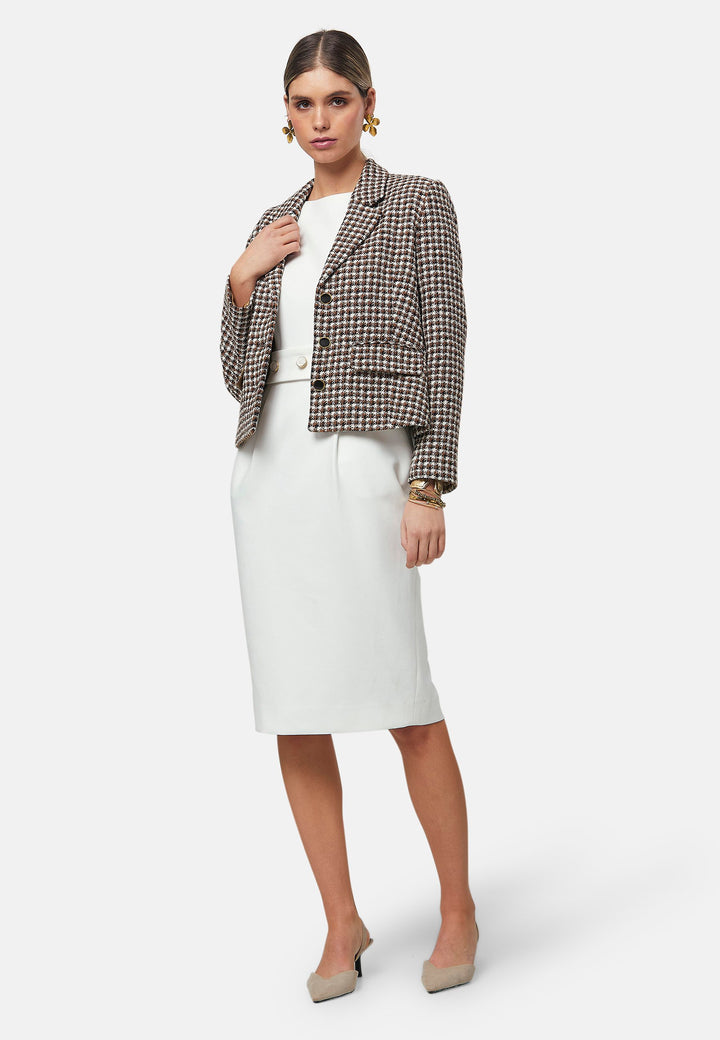 Bianca, a capped-sleeve dress featuring a slash neck and pencil skirt silhouette. Accompanied by a detachable belt featuring gold trimmed pearlescent buttons for the option of a more cinched waistline. Crafted from our signature tricotine with a touch of elastane, ensuring both comfort and movement whilst maintaining a flattering structure. Pair with a trench coat and heels for a chic look.