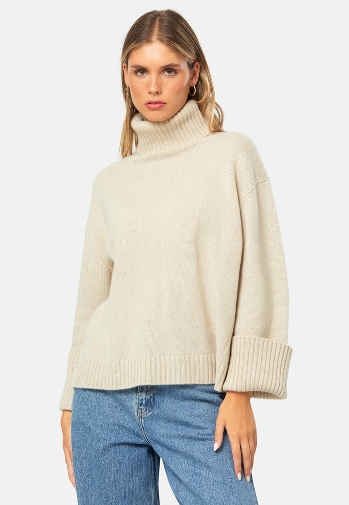 A modern take on the classic roll-neck, knitted in pure cashmere with a cloud-soft handle. Designed with a generous funnel neckline that can be folded or worn slouched, it features dropped shoulders and wide turn-back cuffs. The boxy, hip-skimming silhouette is finished with a deep rib hem for clean structure. Effortless with denim off-duty, refined with tailored trousers, and perfect layered under a long coat.