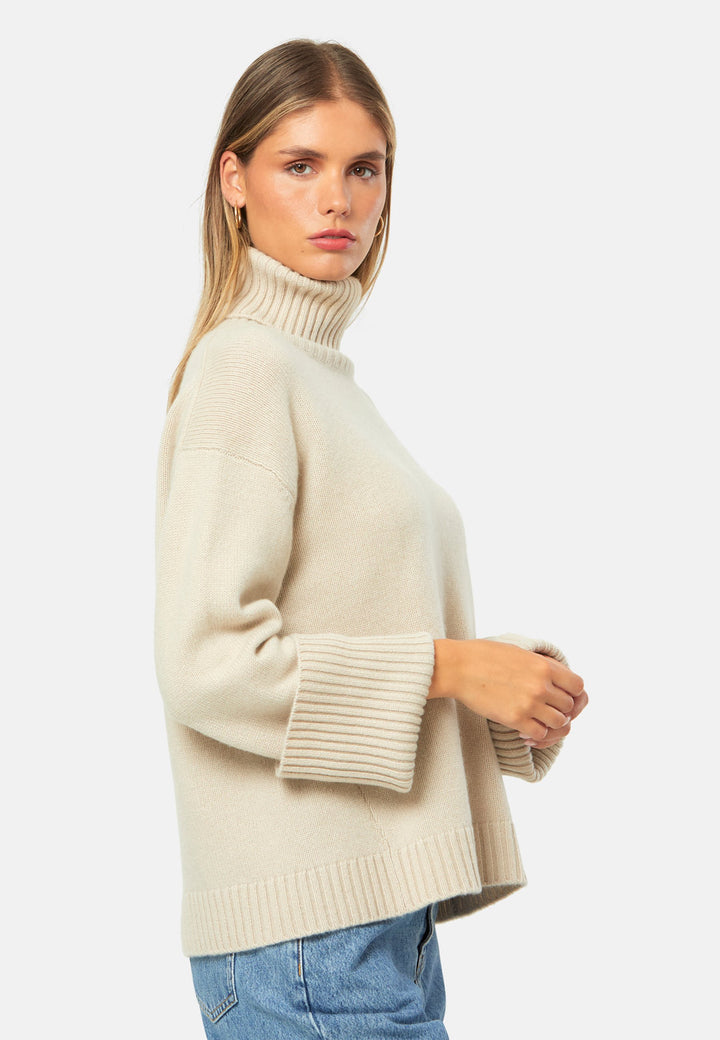 A modern take on the classic roll-neck, knitted in pure cashmere with a cloud-soft handle. Designed with a generous funnel neckline that can be folded or worn slouched, it features dropped shoulders and wide turn-back cuffs. The boxy, hip-skimming silhouette is finished with a deep rib hem for clean structure. Effortless with denim off-duty, refined with tailored trousers, and perfect layered under a long coat.