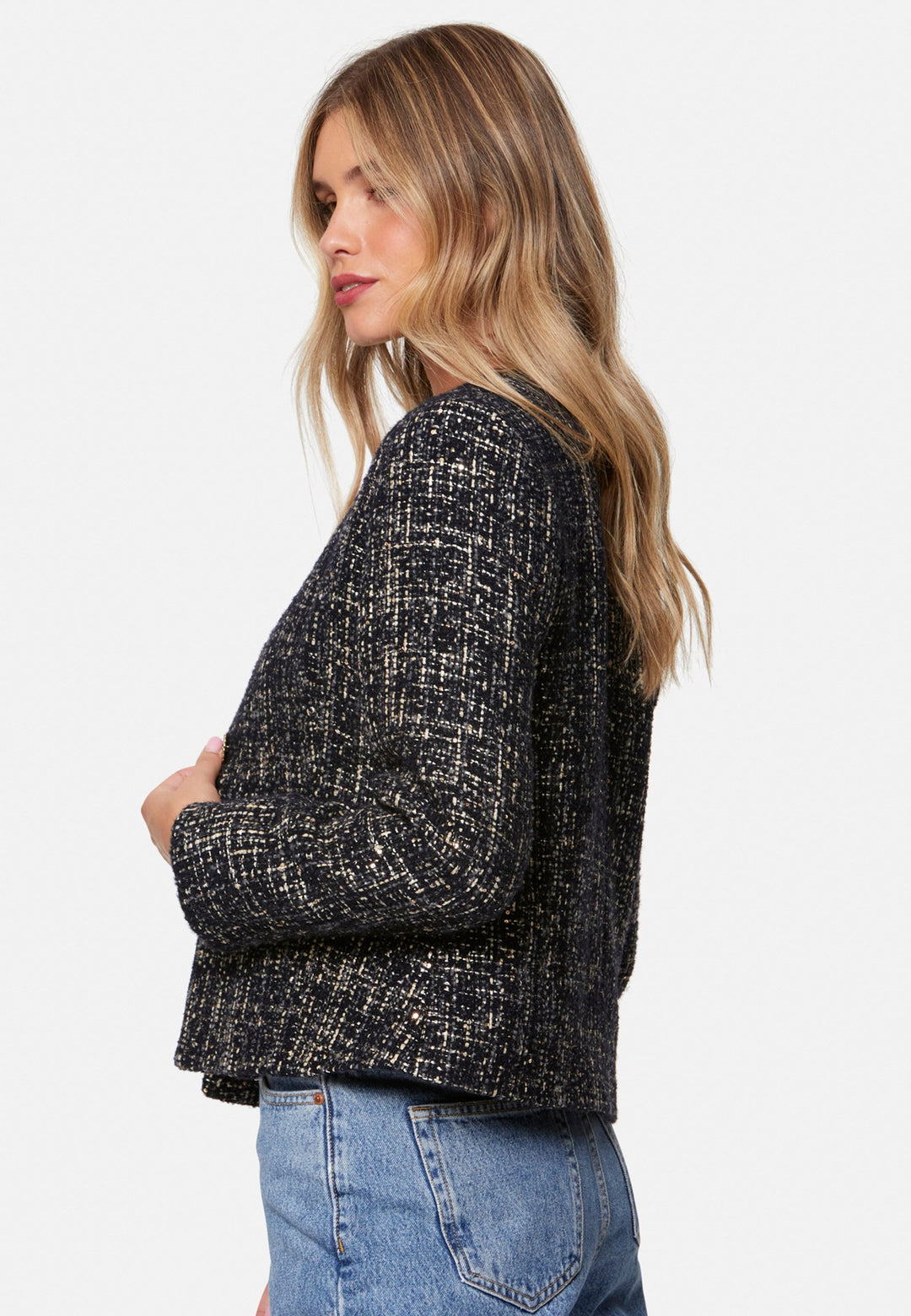 Cassandra, the navy bouclé jacket that pulls everything together. Cut to a neat, waist-defining silhouette with a clean round neckline and long sleeves, it’s woven in textured navy bouclé flecked with light neutrals and burnished metallic threads. Statement gold-rim buttons add polish, while the hip-skimming length makes it effortless over dresses, denim or tailoring. Style with the Lyra or Georgina trousers for a modern suit, or throw on with a tee for off-duty chic.