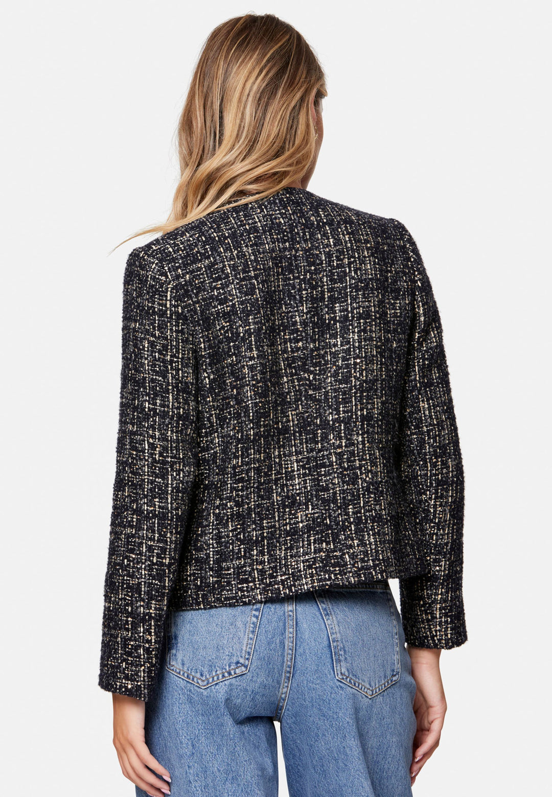Cassandra, the navy bouclé jacket that pulls everything together. Cut to a neat, waist-defining silhouette with a clean round neckline and long sleeves, it’s woven in textured navy bouclé flecked with light neutrals and burnished metallic threads. Statement gold-rim buttons add polish, while the hip-skimming length makes it effortless over dresses, denim or tailoring. Style with the Lyra or Georgina trousers for a modern suit, or throw on with a tee for off-duty chic.