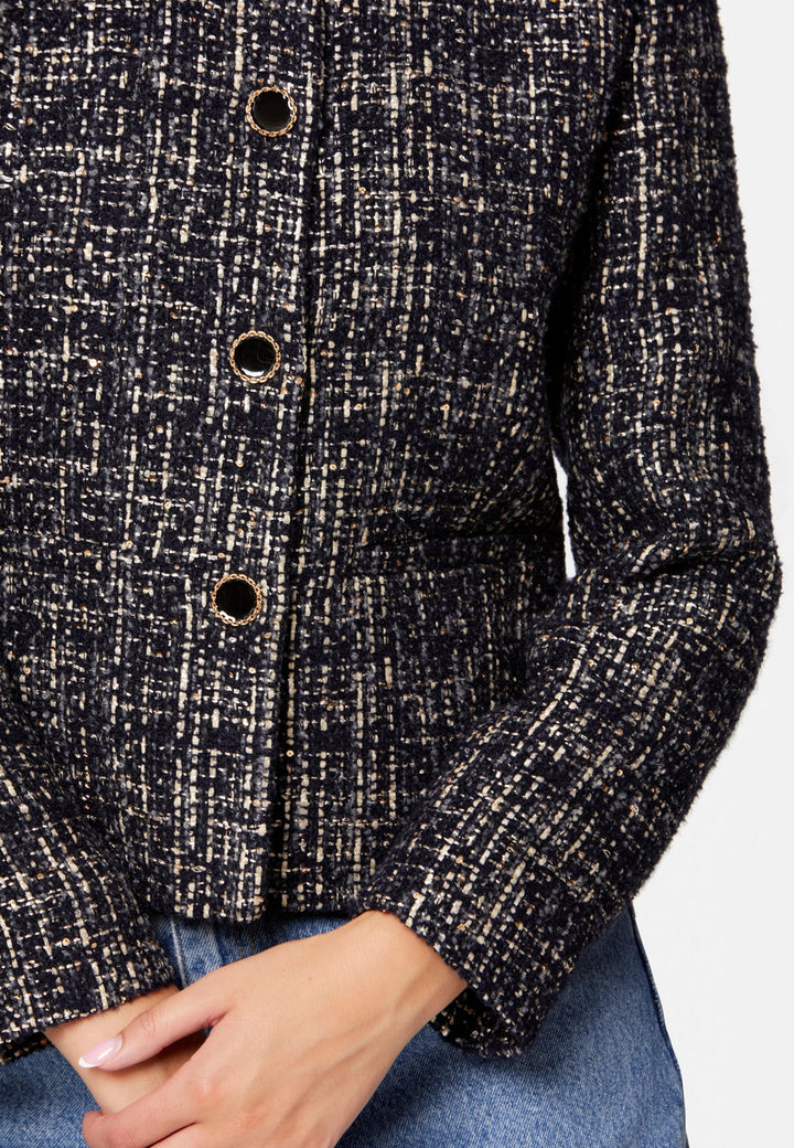 Cassandra, the navy bouclé jacket that pulls everything together. Cut to a neat, waist-defining silhouette with a clean round neckline and long sleeves, it’s woven in textured navy bouclé flecked with light neutrals and burnished metallic threads. Statement gold-rim buttons add polish, while the hip-skimming length makes it effortless over dresses, denim or tailoring. Style with the Lyra or Georgina trousers for a modern suit, or throw on with a tee for off-duty chic.