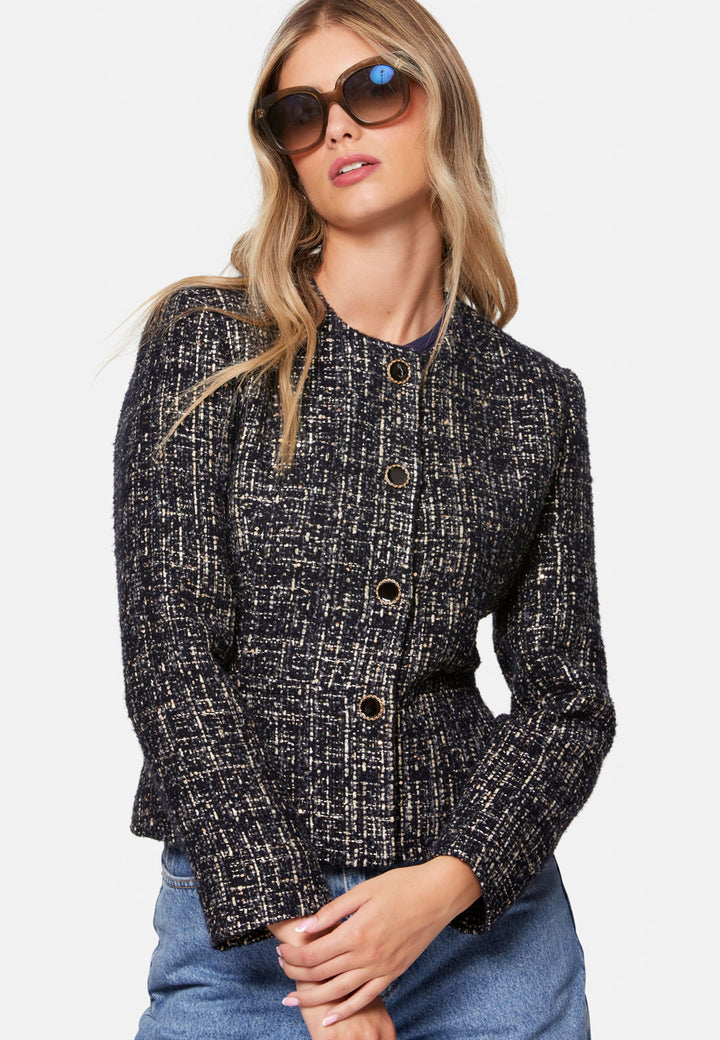 Cassandra, the navy bouclé jacket that pulls everything together. Cut to a neat, waist-defining silhouette with a clean round neckline and long sleeves, it’s woven in textured navy bouclé flecked with light neutrals and burnished metallic threads. Statement gold-rim buttons add polish, while the hip-skimming length makes it effortless over dresses, denim or tailoring. Style with the Lyra or Georgina trousers for a modern suit, or throw on with a tee for off-duty chic.