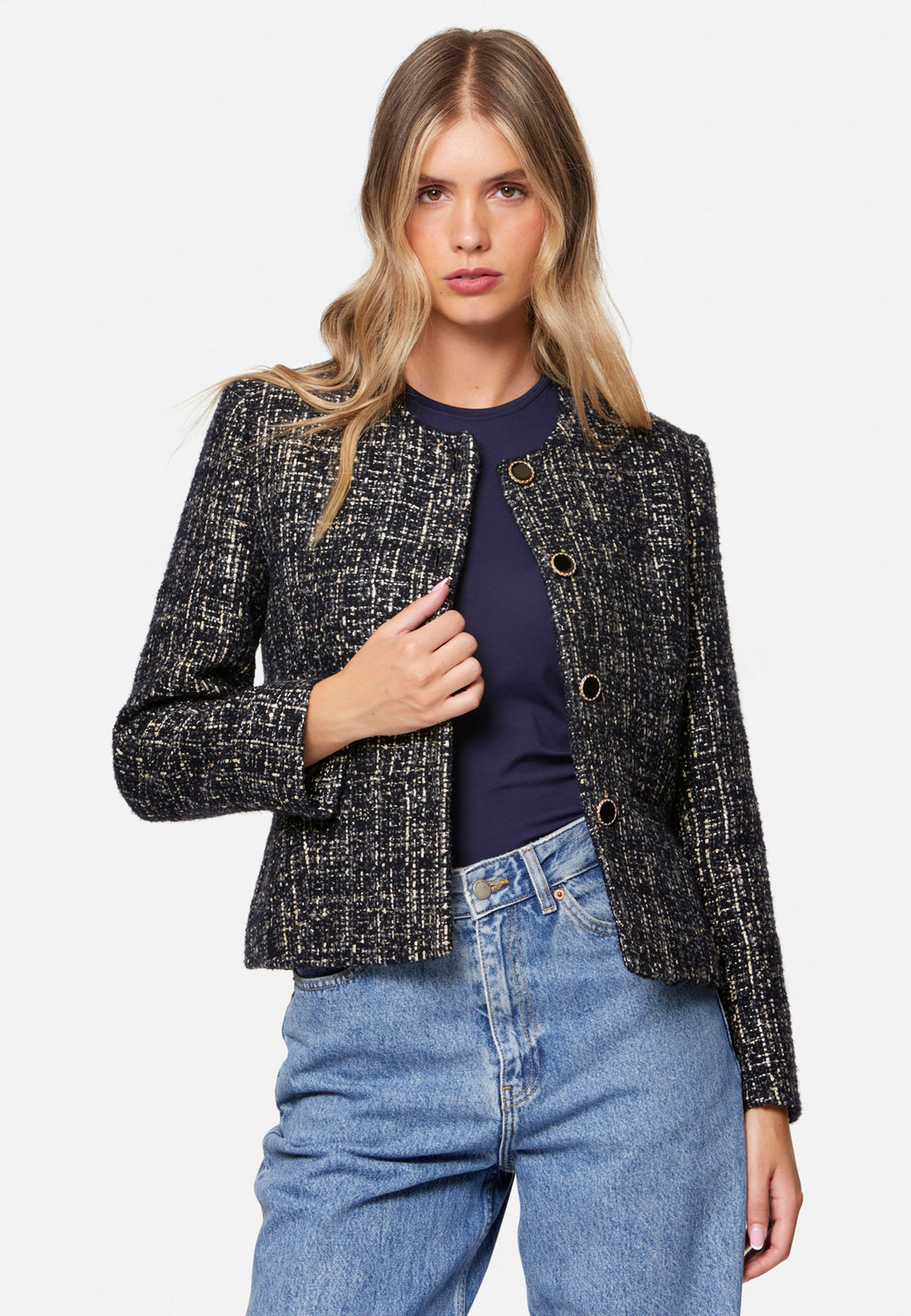 Cassandra, the navy bouclé jacket that pulls everything together. Cut to a neat, waist-defining silhouette with a clean round neckline and long sleeves, it’s woven in textured navy bouclé flecked with light neutrals and burnished metallic threads. Statement gold-rim buttons add polish, while the hip-skimming length makes it effortless over dresses, denim or tailoring. Style with the Lyra or Georgina trousers for a modern suit, or throw on with a tee for off-duty chic.