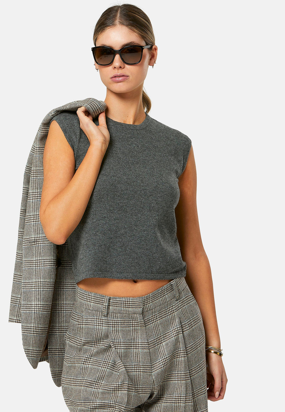The Cassie Glen Check Jacket, a contemporary silhouette crafted in a soft-touch Magee lamsbwool. This boyfriend blazer boasts a minimalist design with a single button fastening and an oversized, slightly boxy silhouette. Pair the Marlena sleeveless cashmere top and matching Lyra Trousers, an effortless outfit.