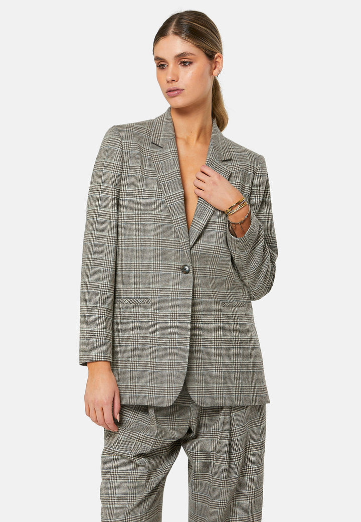 The Cassie Glen Check Jacket, a contemporary silhouette crafted in a soft-touch Magee lamsbwool. This boyfriend blazer boasts a minimalist design with a single button fastening and an oversized, slightly boxy silhouette. Pair the Marlena sleeveless cashmere top and matching Lyra Trousers, an effortless outfit.