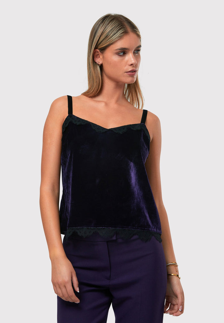 Crafted from a viscose and silk blend with a hint of stretch, the Cleo Velvet Cami in twilight plum features delicate black lace trim on the neckline and hem, complemented by black velvet straps. Pair with the matching velvet suit for a full glam winter look or style with a simple tailored tux for understated elegance.