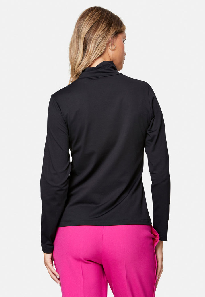 woman wearing high neck and long-sleeved black top with pink trouser
