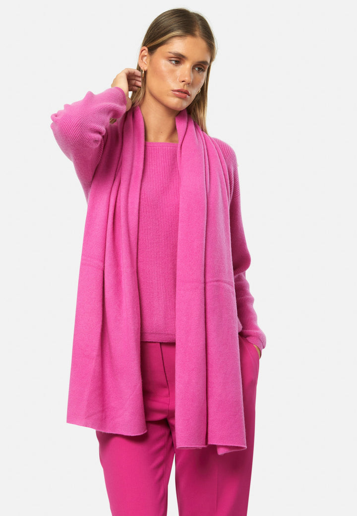 Knitted in pure cashmere with a soft handle, this generously cut wrap drapes fluidly. Loop, wrap or wear as a shoulder cover-up. It’s the easiest way to add colour to winter dressing. Pair with coordinating cashmere for a polished monotone look.